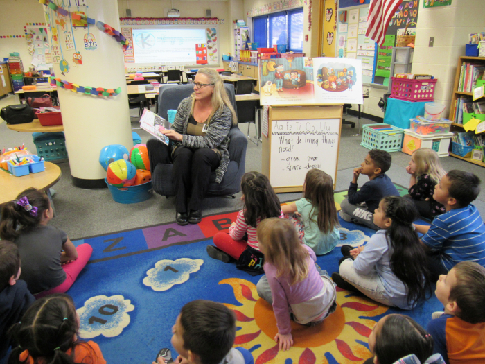 Business Partner reading to a class